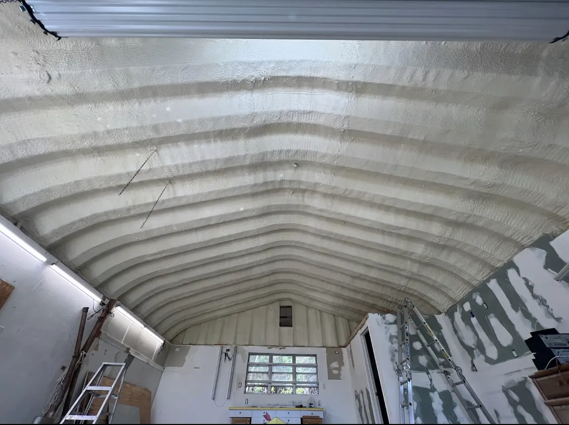 Spray polyurethane foam applied to the underside of a metal roof deck in Villas